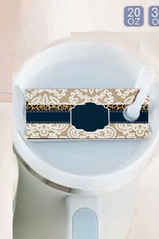 A close-up of a white tumbler with handle, featuring a blank ornate label for the Custom Lace Stanley Lid Plate/Topper by Kreative Kreationz and a white straw. Sizes—20 oz, 30 oz, 40 oz—are displayed in the top right corner.