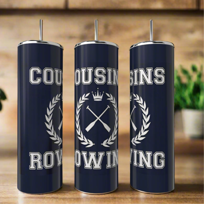 Three Cousins Collection 20oz tumblers by Kreative Kreationz in navy blue stainless steel with silver lids and straws are shown. They feature "COUSINS ROWING" with a crest of oars and crown, set against blurred plants and wood shelves. Eco-friendly & reusable.