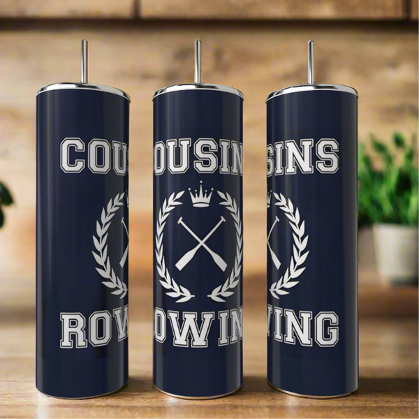 Three Cousins Collection 20oz tumblers by Kreative Kreationz in navy blue stainless steel with silver lids and straws are shown. They feature "COUSINS ROWING" with a crest of oars and crown, set against blurred plants and wood shelves. Eco-friendly & reusable.
