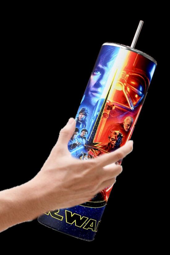 A hand holds the Kreative Kreationz Star Wars 20oz Tumbler, featuring vivid character and lightsaber images on a black background. Complete with a reusable straw and spill-proof lid, it's ideal for fans on the go.