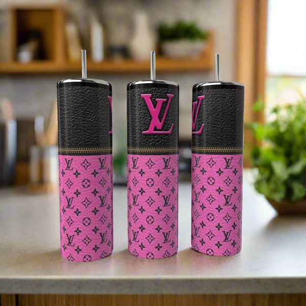 Three Kreative Kreationz LV 20oz Tumblers with metal straws, featuring black and pink Louis Vuitton-inspired designs, sit on a kitchen counter—stylish, eco-friendly drinkware for a luxe touch.
