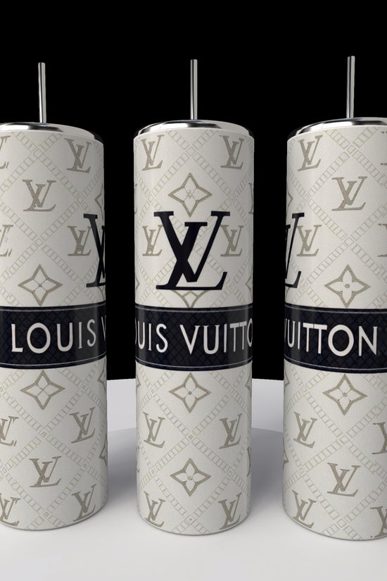 Three LV 20oz Skinny Tumblers by Kreative Kreationz are showcased on a white surface. These cylindrical tumblers feature spill-proof lids and display the LV logo with the name in a classic beige and white design, boasting a sleek 20 oz capacity.