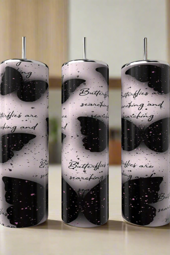 A Louis Vuitton 20oz Tumbler by Kreative Kreationz sits on a kitchen counter beside an eco-friendly reusable straw, with a blurred background.