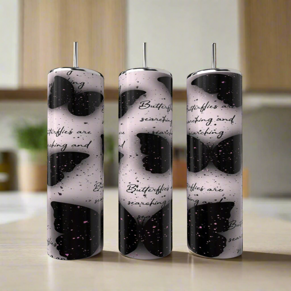 A Louis Vuitton 20oz Tumbler by Kreative Kreationz sits on a kitchen counter beside an eco-friendly reusable straw, with a blurred background.