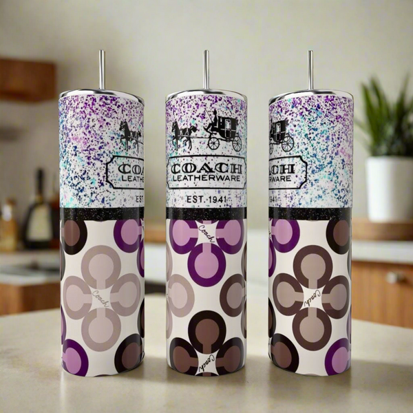 On the kitchen counter are three stainless steel tumblers with metal straws and modern geometric Coach Leatherware patterns, including the stylish Coach Purple Designed 20oz Tumbler by Kreative Kreationz in blue, brown, and purple hues.