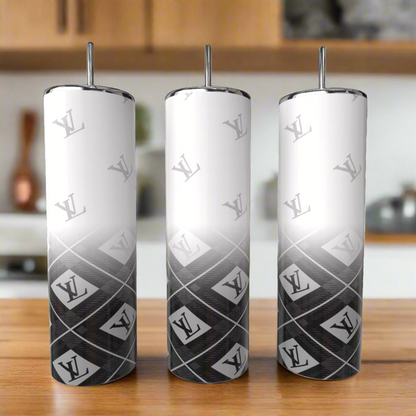 Three Louis V Fade 20oz Tumblers by Kreative Kreationz, each with lids and straws, showcase a white-to-black gradient and repeating logo pattern. Arranged on a wooden kitchen surface, these stainless steel tumblers blend luxury and style.