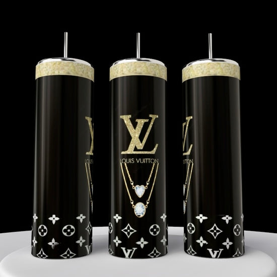 Three Louis Vuitton Purse tumblers by Kreative Kreationz, crafted from sleek stainless steel with silver lids and straws, feature a luxury black-and-gold design and stand adorned with a gold chain pattern on a white surface against a black background.