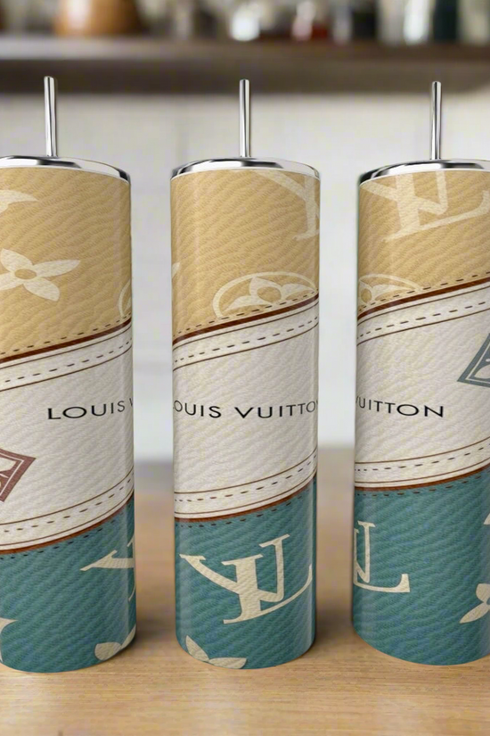 Three (Copy) Louis Vuitton Purse Designed 20oz Tumblers by Kreative Kreationz, with metallic handles and a luxury beige, white, and teal pattern, are displayed on a wooden surface in a modern kitchen.