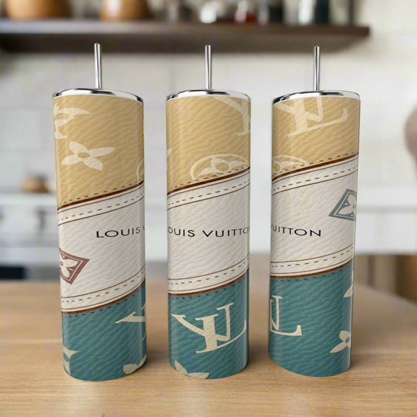 Three (Copy) Louis Vuitton Purse Designed 20oz Tumblers by Kreative Kreationz, with metallic handles and a luxury beige, white, and teal pattern, are displayed on a wooden surface in a modern kitchen.