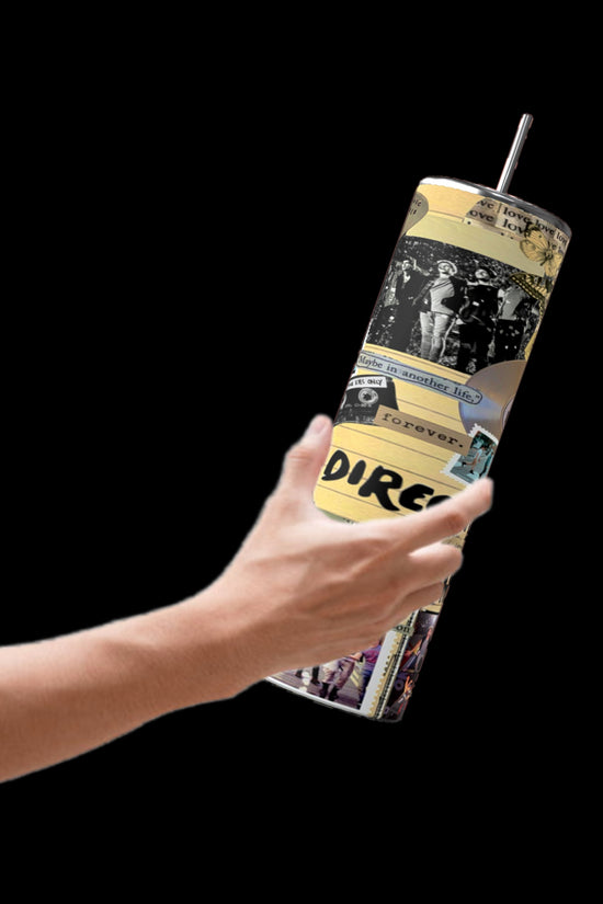 A hand holds the One Direction Aesthetic Collage 20oz Stainless Steel Tumbler by Kreative Kreationz, featuring a vibrant collage of black and yellow comic-style illustrations and text, designed for durability. The background is a striking black.