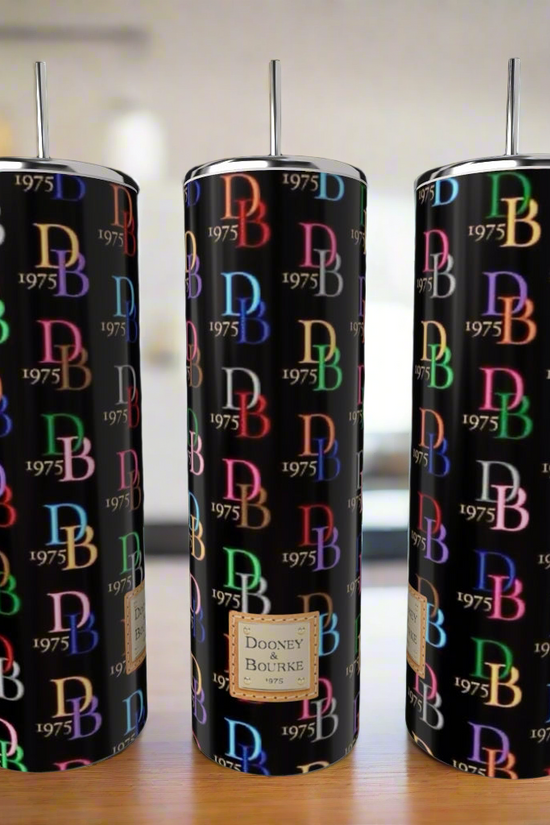 Three Dooney & Bourke 20oz Tumblers by Kreative Kreationz, featuring lids and straws, display a luxury-inspired multicolored 