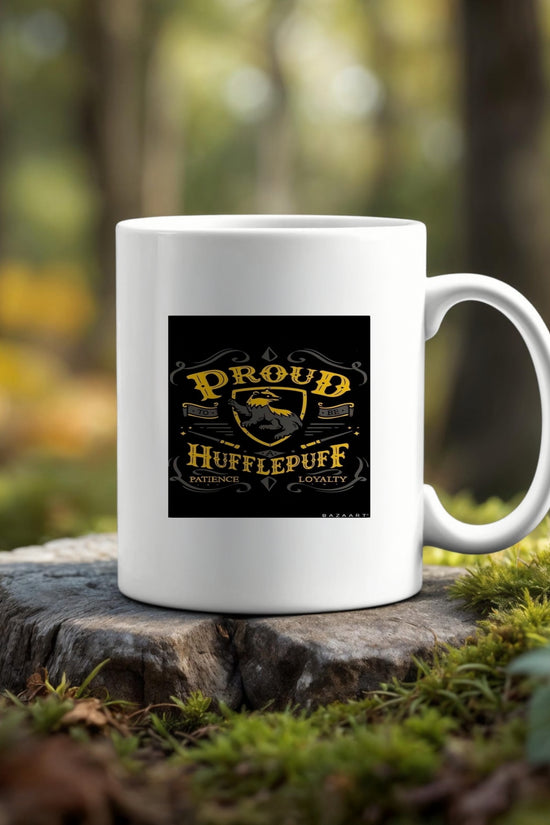 The Proud Hufflepuff Ceramic Mug by Kreative Kreationz, with an 11 oz capacity and “Proud Hufflepuff. Patience. Loyalty.” design, sits on a tree stump outdoors—an eco-friendly choice for Harry Potter fans.
