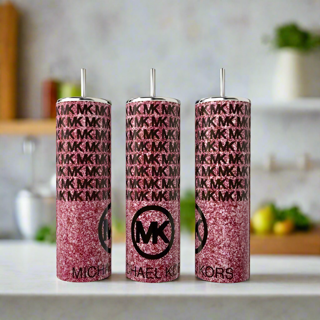 Three MK Pink Glittered 20oz Tumblers by Kreative Kreationz feature a sparkly pink finish with silver straws and luxe-inspired design, displayed on a white countertop against a softly blurred kitchen backdrop.