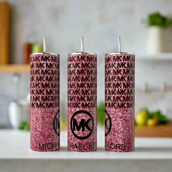 Three MK Pink Glittered 20oz Tumblers by Kreative Kreationz feature a sparkly pink finish with silver straws and luxe-inspired design, displayed on a white countertop against a softly blurred kitchen backdrop.