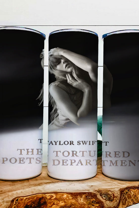Three tall candles with black and white images sit on a wooden surface. The center one, styled like a Kreative Kreationz TTPD | Tumbler, features someone posing with hands near their face. The text reads 