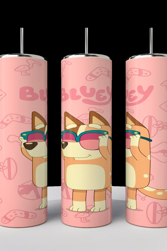 This set of three pink, stainless steel Bluey 20oz tumblers from Kreative Kreationz features a cartoon dog with sunglasses and playful icons like bones and paw prints. Each sublimated tumbler prominently displays the word 