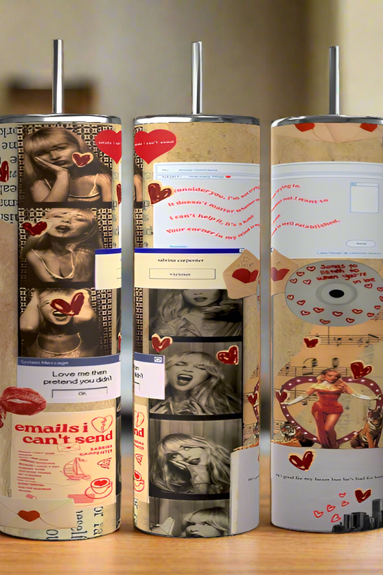 Three cylindrical Sabrina Carpenter Emails I Couldn't Send Tumblers by Kreative Kreationz, featuring handles, a luxury-inspired design with black-and-white photos, heart stickers, email text, and colorful emoticons. They stand on a wooden surface in a softly blurred kitchen setting.