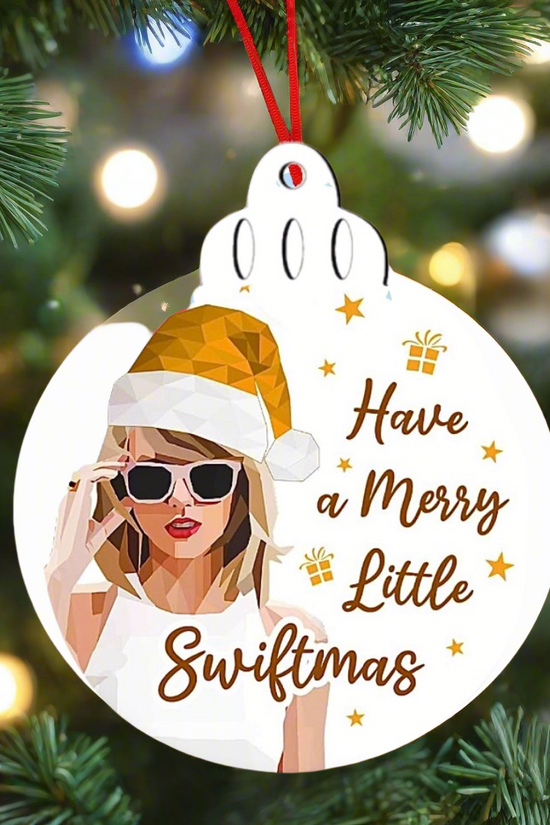 The Happy Swiftmas Tree Ornament by Kreative Kreationz is a festive decor piece featuring a polygonal blonde in a Santa hat and sunglasses, with the playful phrase 