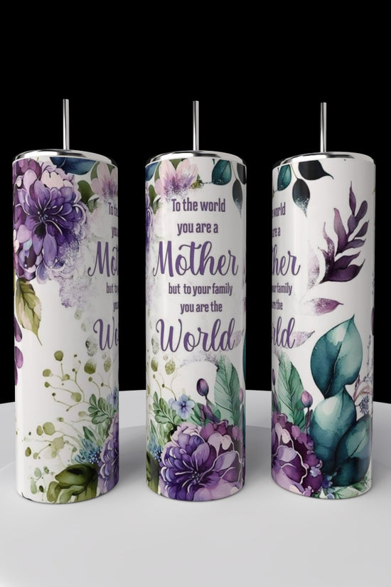 Three Kreative Kreationz Mom 20oz Tumblers with straws sit on a white platform, each featuring purple and green botanical designs and the message: 