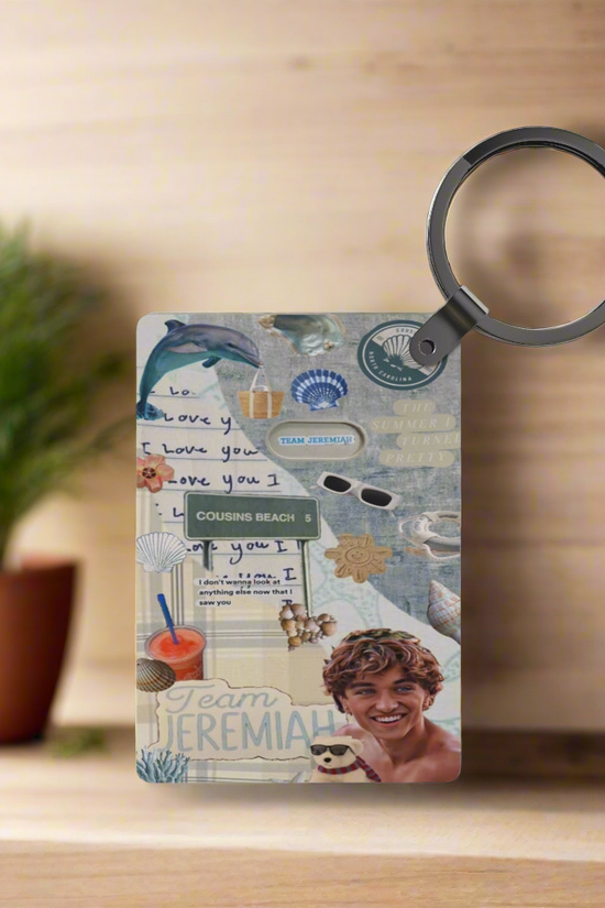The Team Jeremiah Inspired Keychain by Kreative Kreationz features seaside elements—sunglasses, seashells, “Team Jeremiah”—set at Cousins Beach with a smiling young man, “I love you” notes, and a potted plant on wood.