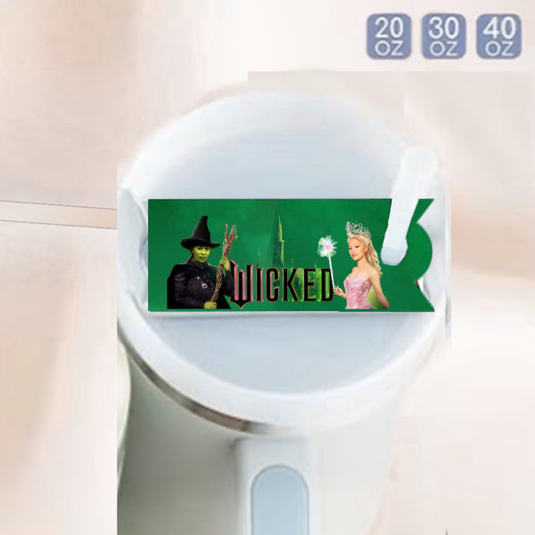 The Wicked -Stanley Lid Topper by Kreative Kreationz features a green Wicked-themed label with two characters on the Stanley tumbler’s white lid and size options (20 oz, 30 oz, 40 oz) in the upper right. A fun, durable tumbler accessory!.
