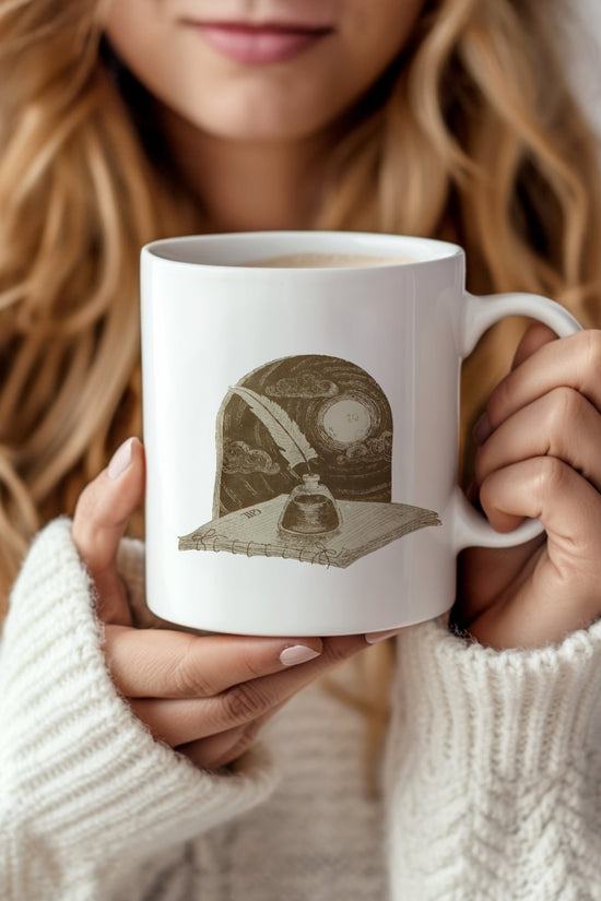 A woman in a cozy white sweater holds the TTPD Writers Ceramic Mug by Kreative Kreationz, featuring a quill pen, inkwell, and book against a starry night sky—the perfect Swiftie gift for any fan.