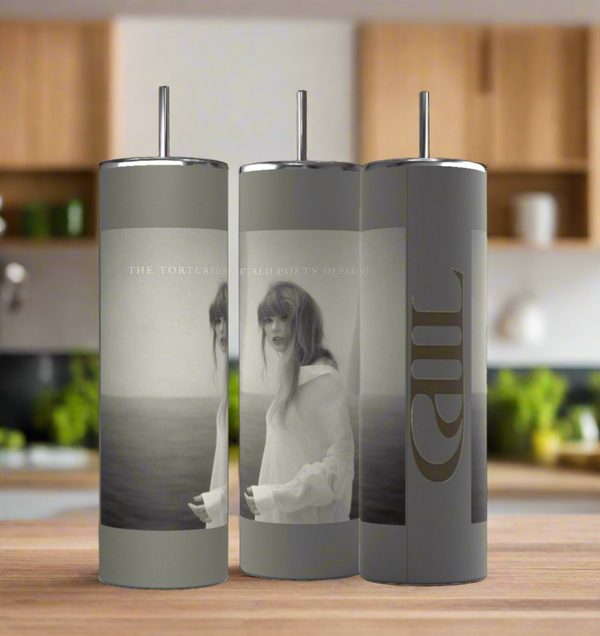 Three Kreative Kreationz TTPD grey 20oz tumblers with straws are displayed on a modern kitchen counter, featuring grayscale ocean-themed images of a woman and "THE TORTURED POETS DEPARTMENT" text on the front.