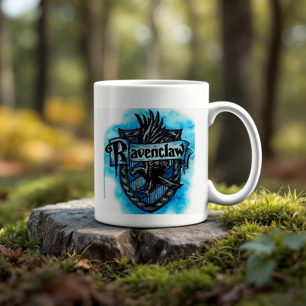 The Ravenclaw Ceramic Mug by Kreative Kreationz features a blue crest design and sits on a tree stump outdoors, blending with greenery and trees—an eco-friendly choice for any Harry Potter fan.