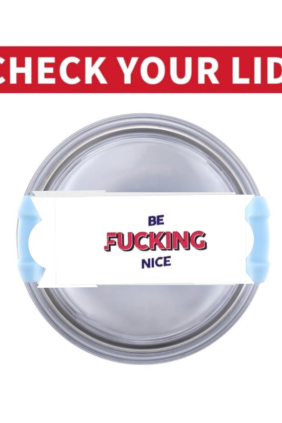Close-up of a round, gray-colored object with a rectangular card attached to a stick in the middle. The card has the words 