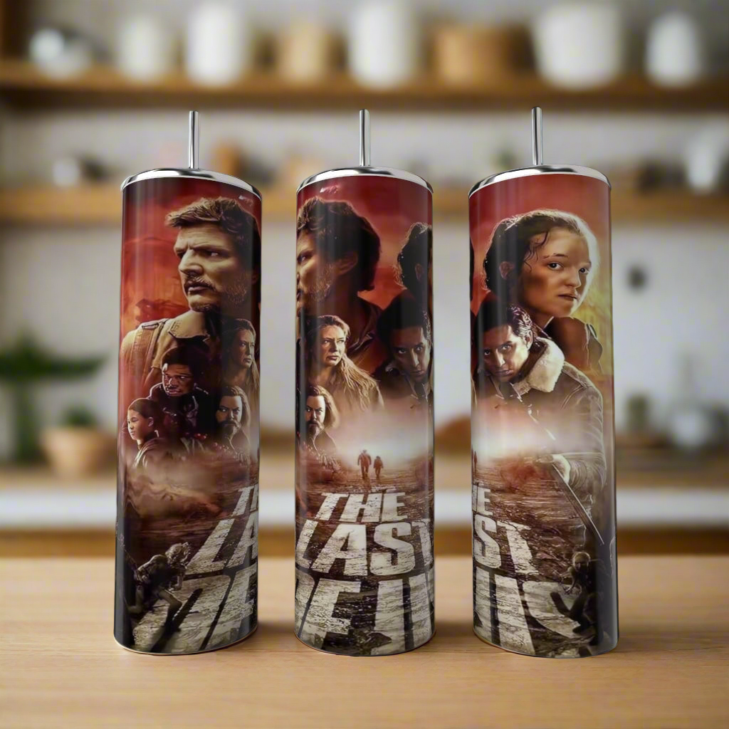 Three Kreative Kreationz "The Last Of Us (Season 1) 20oz Tumblers" sit on a kitchen counter, each showcasing series-inspired artwork of characters and dramatic scenes against a blurred kitchen background.