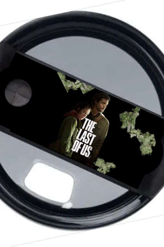 The Last Of Us Stanley Lid Topper by Kreative Kreationz: a black lid featuring two characters, the show's title, and green fungal accents—perfect for fans of the series.