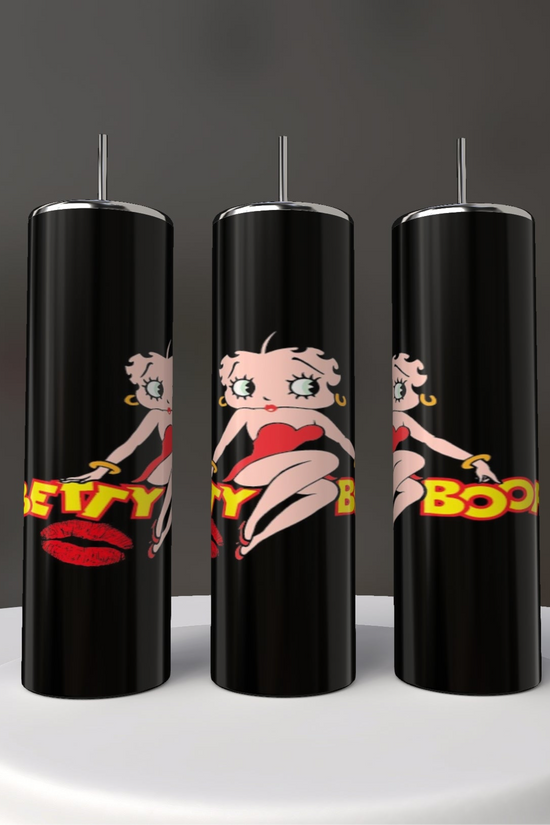Three black tall candles on a white surface feature the iconic cartoon character with short hair and a red dress, alongside 