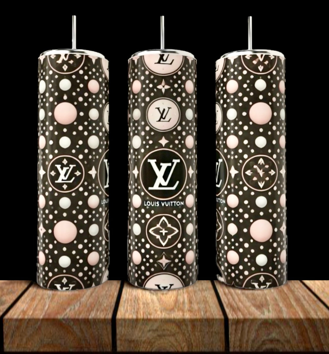 Three LV Pink & Black Abstract 20oz Tumblers by Kreative Kreationz, featuring stylish polka dot patterns and LV logos, stand on a wooden surface—luxury drinkware perfect for any chic setting.