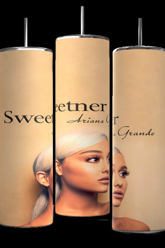 Three tall, cylindrical personalized tumblers with a beige background are displayed against a black backdrop. Each tumbler features a portrait image of a Ariana Grande with long, light-colored hair, along with text that includes the word 