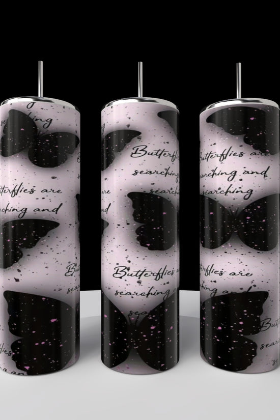 A 20oz Louis Vuitton tumbler by Kreative Kreationz with a luxury-inspired design is displayed on a round white platform—eco-friendly, reusable, and set against a dramatic black backdrop.
