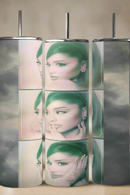The Ariana Grande Aesthetic 20oz skinny tumblers by Kreative Kreationz feature a cylindrical design with faded images of her iconic hairstyle and signature pose, set against a gray cloud-like background for artistic flair.