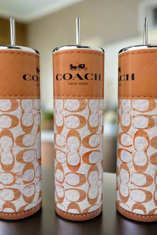 Three tall, cylindrical 20oz tumblers by Kreative Kreationz are lined up on a table. Each features a brown leather-like design with white patterns and the 