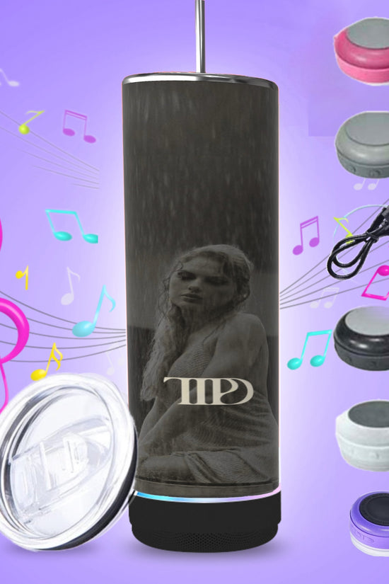 Three tall, cylindrical TTPD Bluetooth Tumblers with dark exteriors and pink bases are aligned. One side of each tumbler features a statue image and the letters 