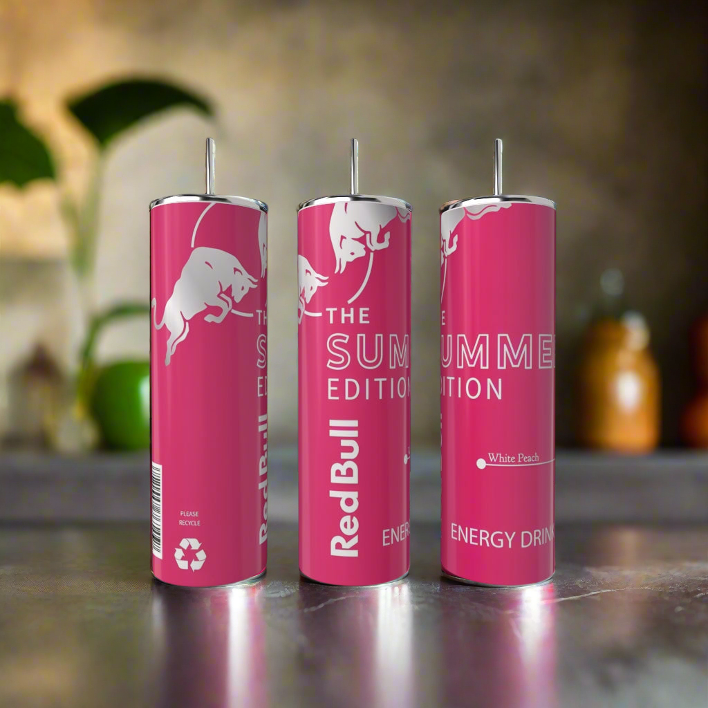 Three Summer Red Bull White Peach 20oz Tumblers by Kreative Kreationz stand upright on a kitchen counter, next to a stainless steel tumbler, with bottles and a plant blurred in the background.