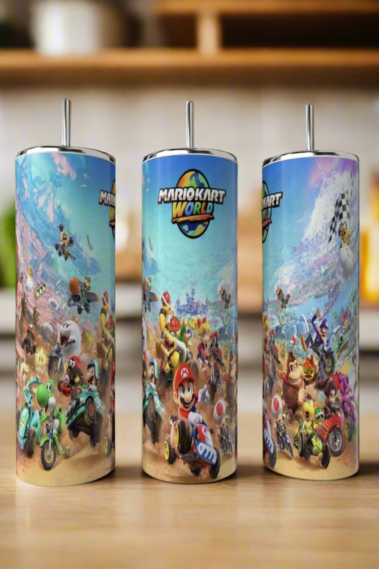 Kreative Kreationz Mario World 20oz Tumblers, made of stainless steel, feature vivid racing scenes with Mario Kart characters. Each eco-friendly tumbler includes a metal straw and is shown on a wooden surface in a bright kitchen setting.