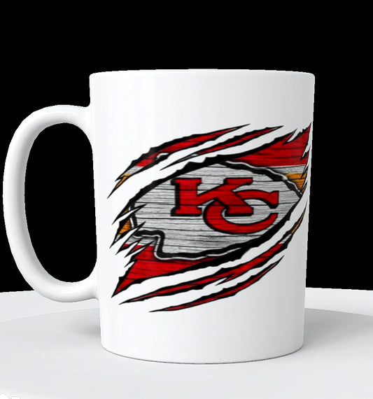The Chiefs Ceramic Mug | 11oz by Kreative Kreationz features the Kansas City Chiefs logo in red and yellow, appearing through claw marks on a wood-look background.