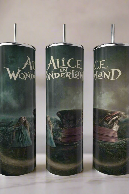 Three Kreative Kreationz Alice in Wonderland 20oz Tumblers with metal straws, featuring dark, whimsical designs and iconic characters, are displayed on a kitchen counter as stylish, eco-friendly drinkware.