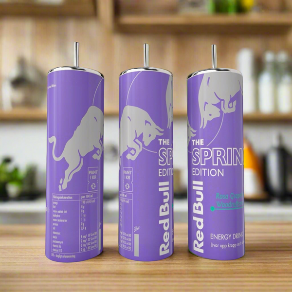 Three Spring purple Red Bull 20oz Tumblers by Kreative Kreationz with straws are displayed on a kitchen counter, featuring a luxury-inspired purple design and white bull logo, with "Rosa Grapefruit & Woodruff" flavor indicated.