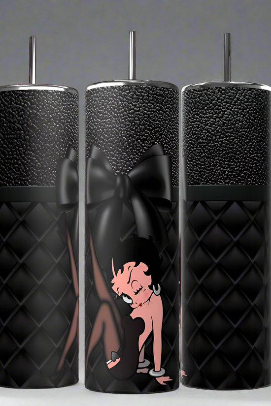 Three Betty 20oz Skinny Tumblers by Kreative Kreationz, featuring a cartoon character and a large black bow design, come with black quilted surfaces, spill-proof lids, and metal straws. They are showcased side by side against a neutral background.