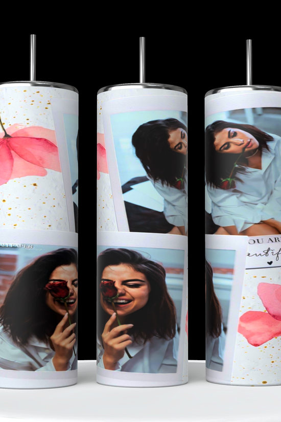 The stylish and sustainable Selena Gomez Coral Collage 20oz Stainless Steel Tumblers by Kreative Kreationz feature eco-friendly designs: a woman with a flower, abstract pink blooms, and gold speckles on a black background with silver lids.