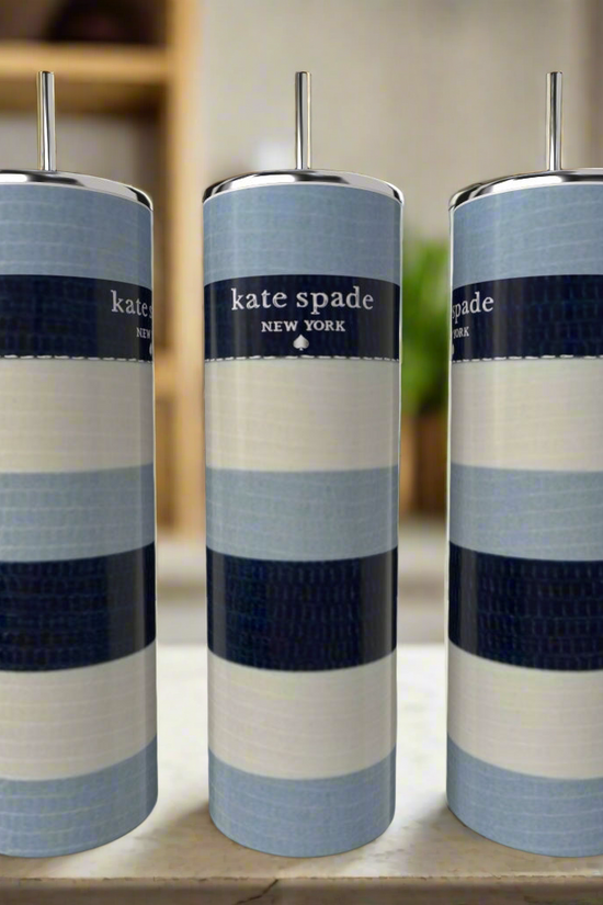 Three Kate Spade Blue Stripe 20oz Skinny Tumblers by Kreative Kreationz, featuring blue, white, and navy bands with metal straws, sit on a light surface. Each stainless steel tumbler displays the 
