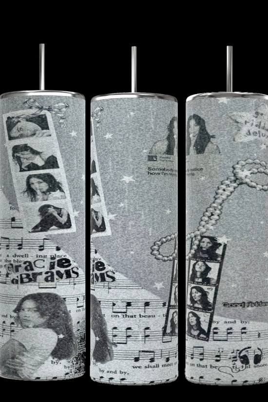 The Kreative Kreationz Gracie Abrams Picture Collage 20oz Skinny Tumbler features a grayscale collage design that includes images of a woman, musical notes, filmstrips, stars, and text elements. These stylish cylindrical tumblers come with reusable straws protruding from the tops.