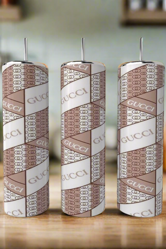 Three cylindrical tumblers featuring a pink 