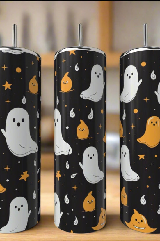 The Kreative Kreationz Ghosts 20oz Tumblers feature cute white and orange ghost designs with stars and sparkles on black backgrounds. Each stainless steel tumbler is shown indoors against a blurred backdrop.