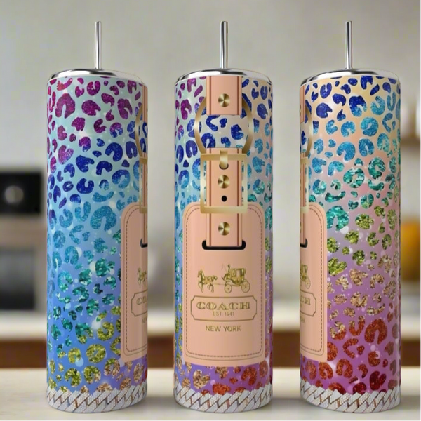 Three tall Kreative Kreationz Minnie Mouse LV Peek-a-Boo 20oz Skinny Tumblers, with metal straws and chic designs, are displayed on a kitchen counter—luxury drinkware that’s as eco-friendly as it is stylish.